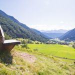 Panoramic view over the green Gsies Valley and the surrounding mountains.