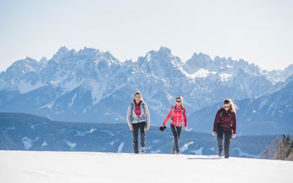 Three women on a winter hike in the Dolomites